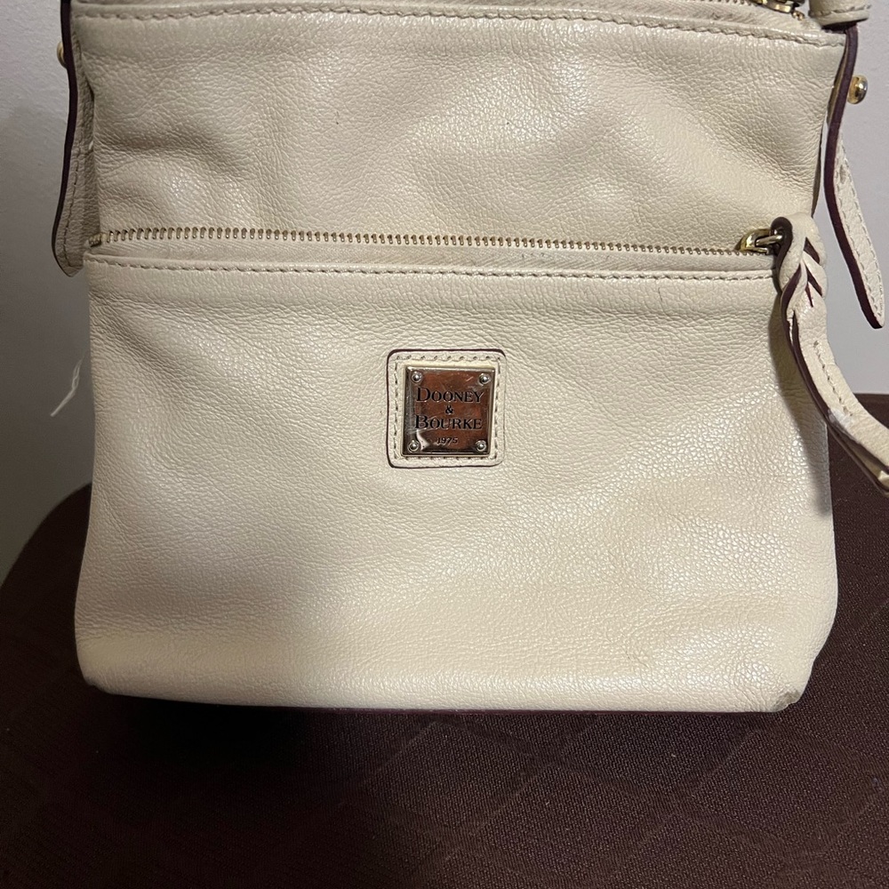 Dooney & Bourke cream colored leather crossbody bag